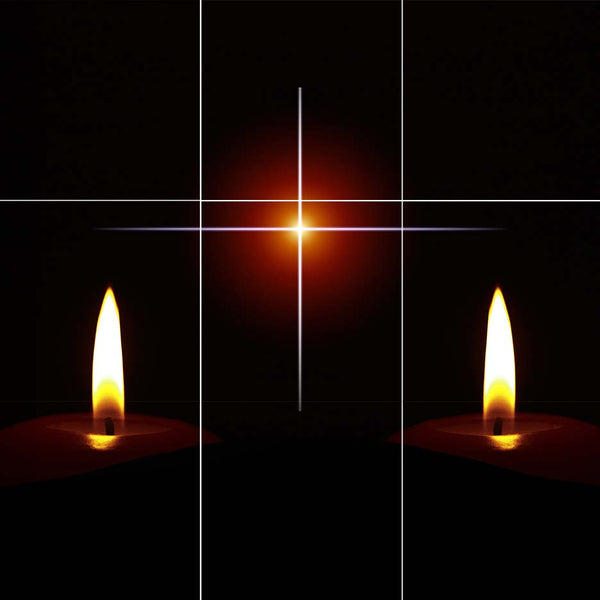 Cross and sun's rays with candles on either side