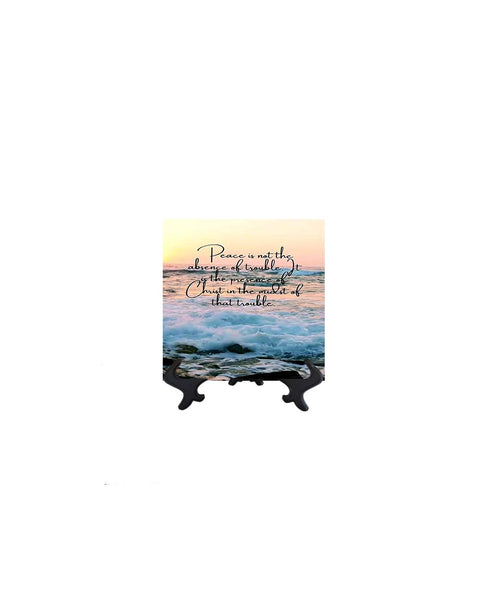 4x4 Peace is not the absence of trouble inspirational quote on ceramic tile with ocean & sunset backdrop on stand & no background