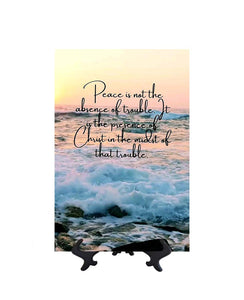 8x12 Peace is not the absence of trouble inspirational quote on ceramic tile with ocean & sunset backdrop on stand & no background