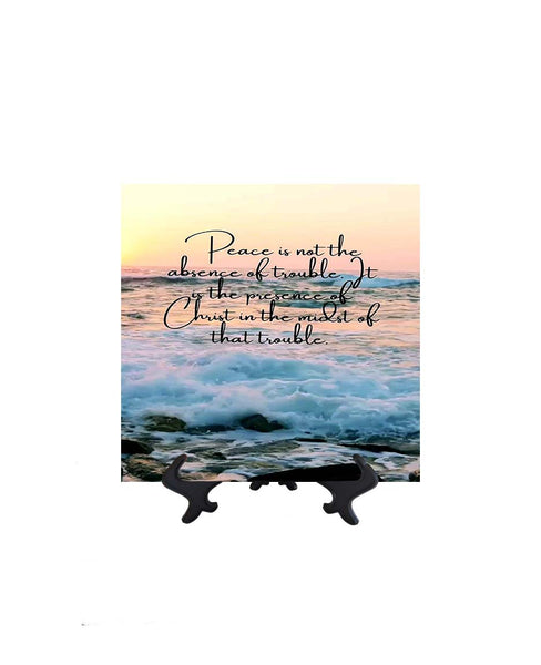 8x8 Peace is not the absence of trouble inspirational quote on ceramic tile with ocean & sunset backdrop on stand & no background
