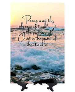 Main Peace is not the absence of trouble inspirational quote on ceramic tile with ocean & sunset backdrop on stand & no background