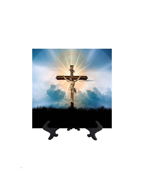 8x8  Christ crucified on ceramic tile with blue clouds & sky & sun's golden rays as a backdrop. Ceramic tile on stand & no background