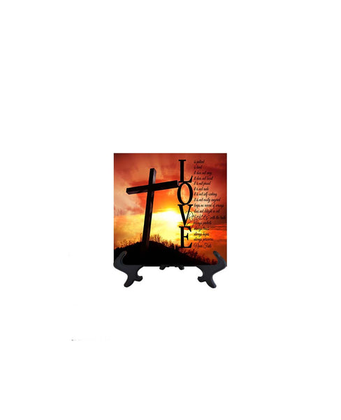 4x4 Black text Love is patient bible quote with cross & sun's rays as backdrop on ceramic tile & stand