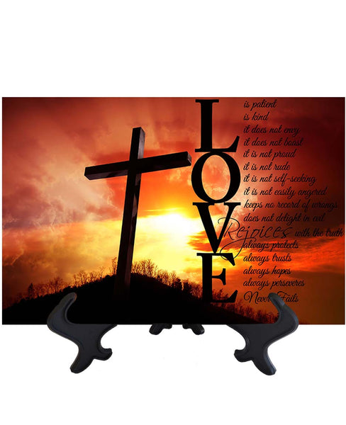 Main Love is Patient black text bible quote with cross & sun's rays as backdrop on ceramic tile & stand & no background